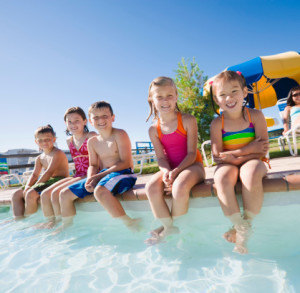 Kids sitting by pool